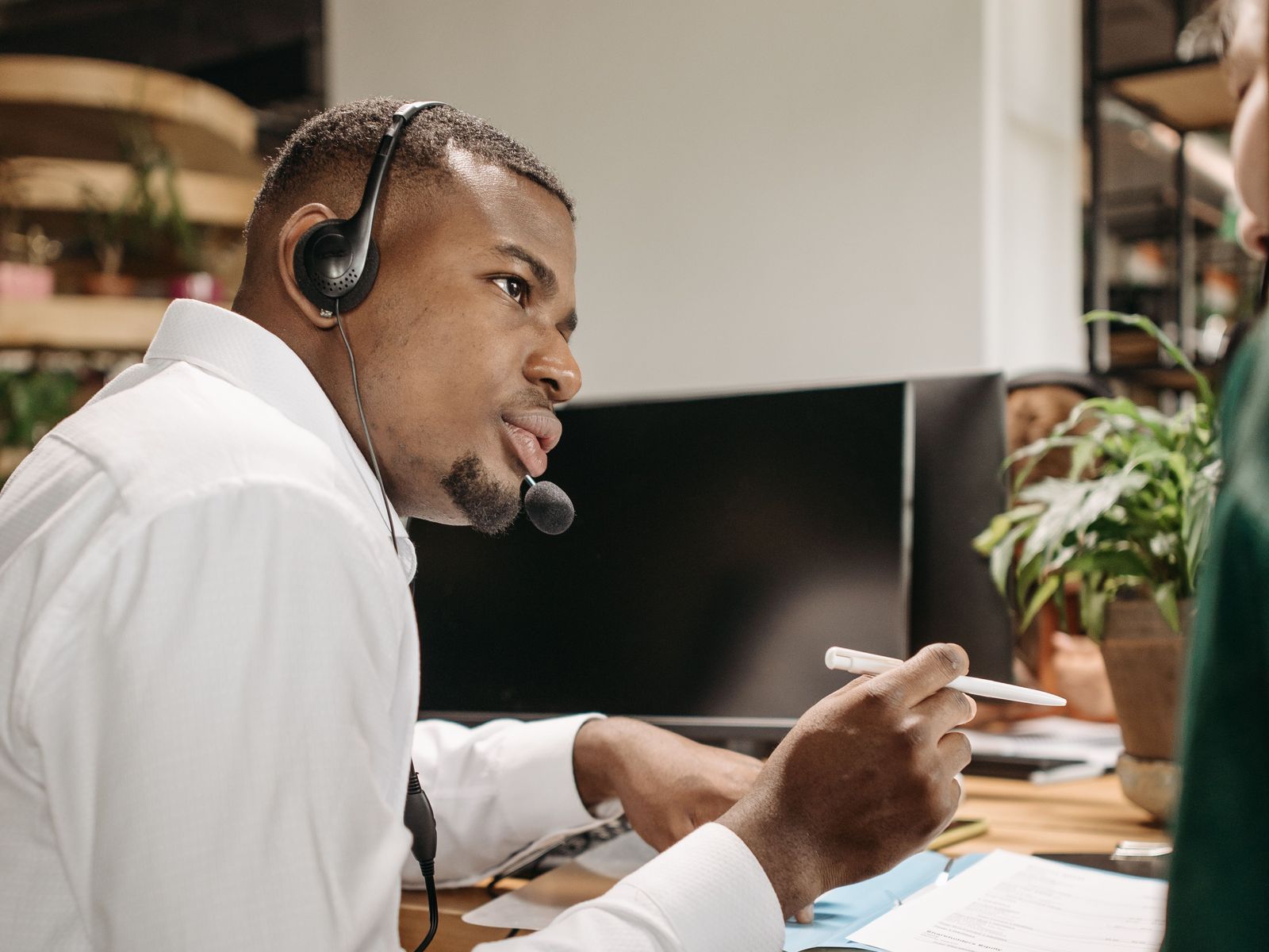 Support engineer with a headset helping a customer