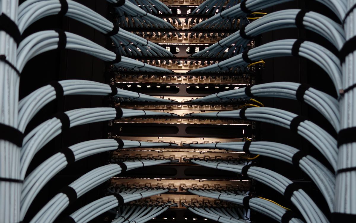 Neatly bundled network cables running into patch panels