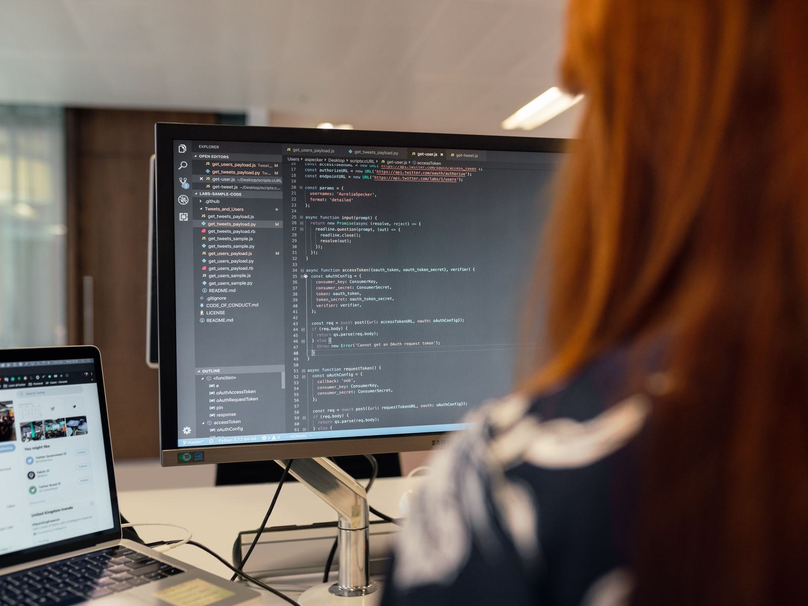 Code on a large monitor at a developer desk