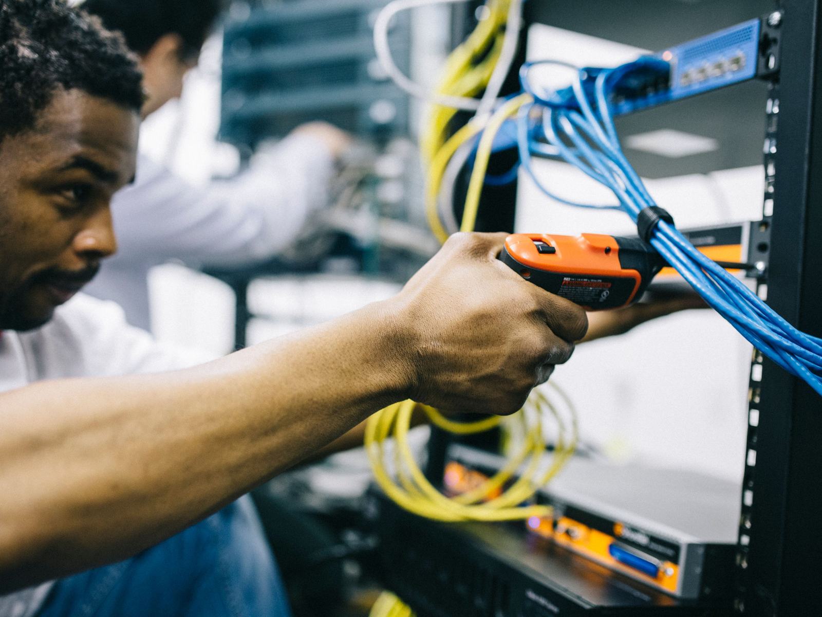 Engineer fitting equipment into a network rack